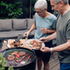 A couple enjoying a backyard barbeque